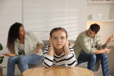 Photo of Divorce concept. Angry couple arguing at home, focus on their sad daughter