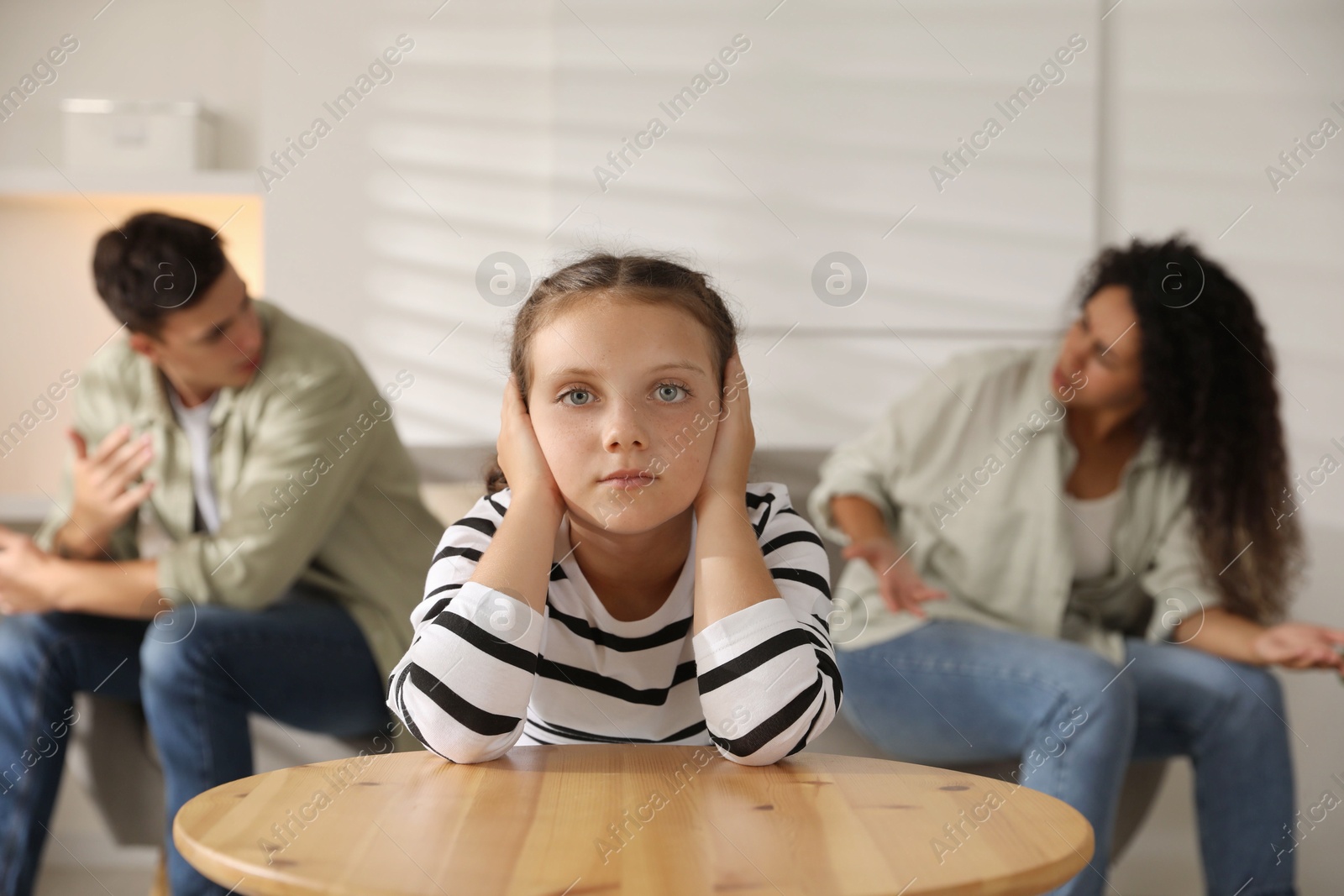 Photo of Divorce concept. Angry couple arguing at home, focus on their sad daughter