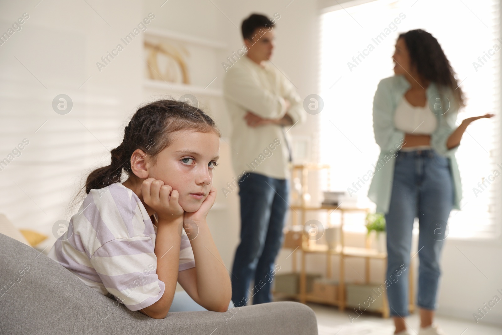 Photo of Divorce concept. Angry couple arguing at home, focus on their sad daughter