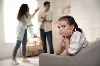 Photo of Divorce concept. Angry couple arguing at home, focus on their sad daughter