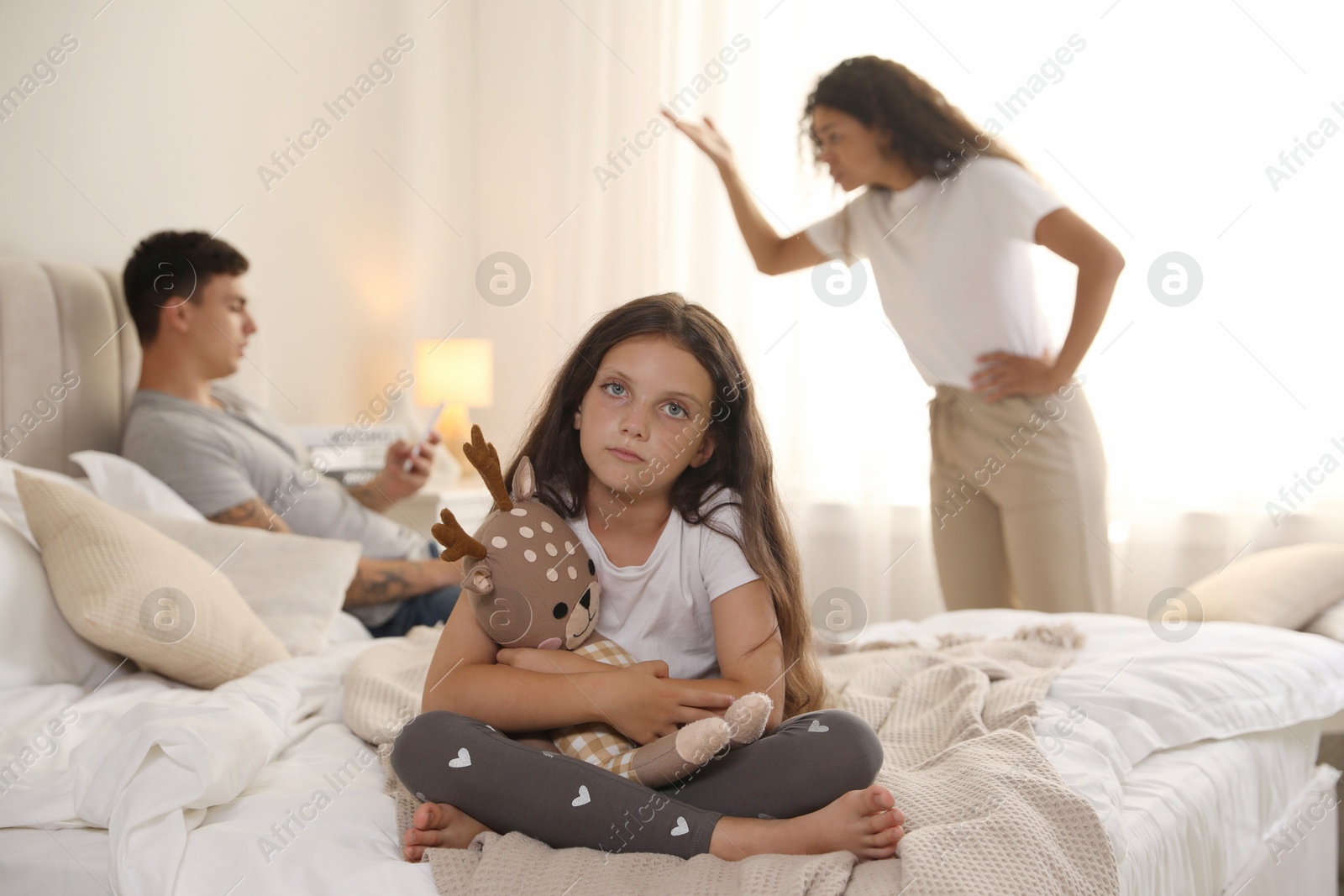 Photo of Divorce concept. Angry couple arguing at home, focus on their sad daughter