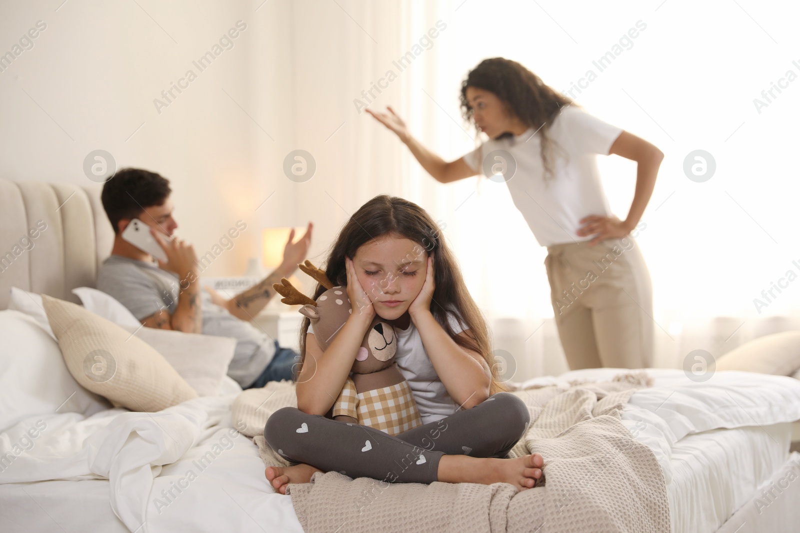 Photo of Divorce concept. Angry couple arguing at home, focus on their sad daughter