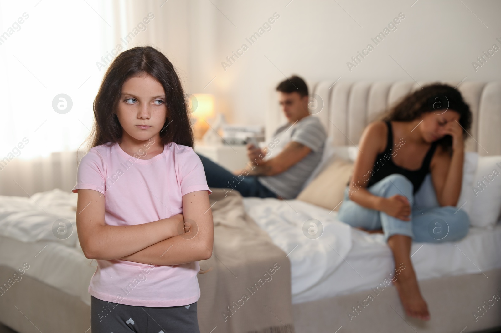 Photo of Divorce concept. Sad couple in bedroom, focus on their unhappy daughter