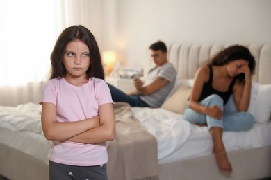 Photo of Divorce concept. Sad couple in bedroom, focus on their unhappy daughter