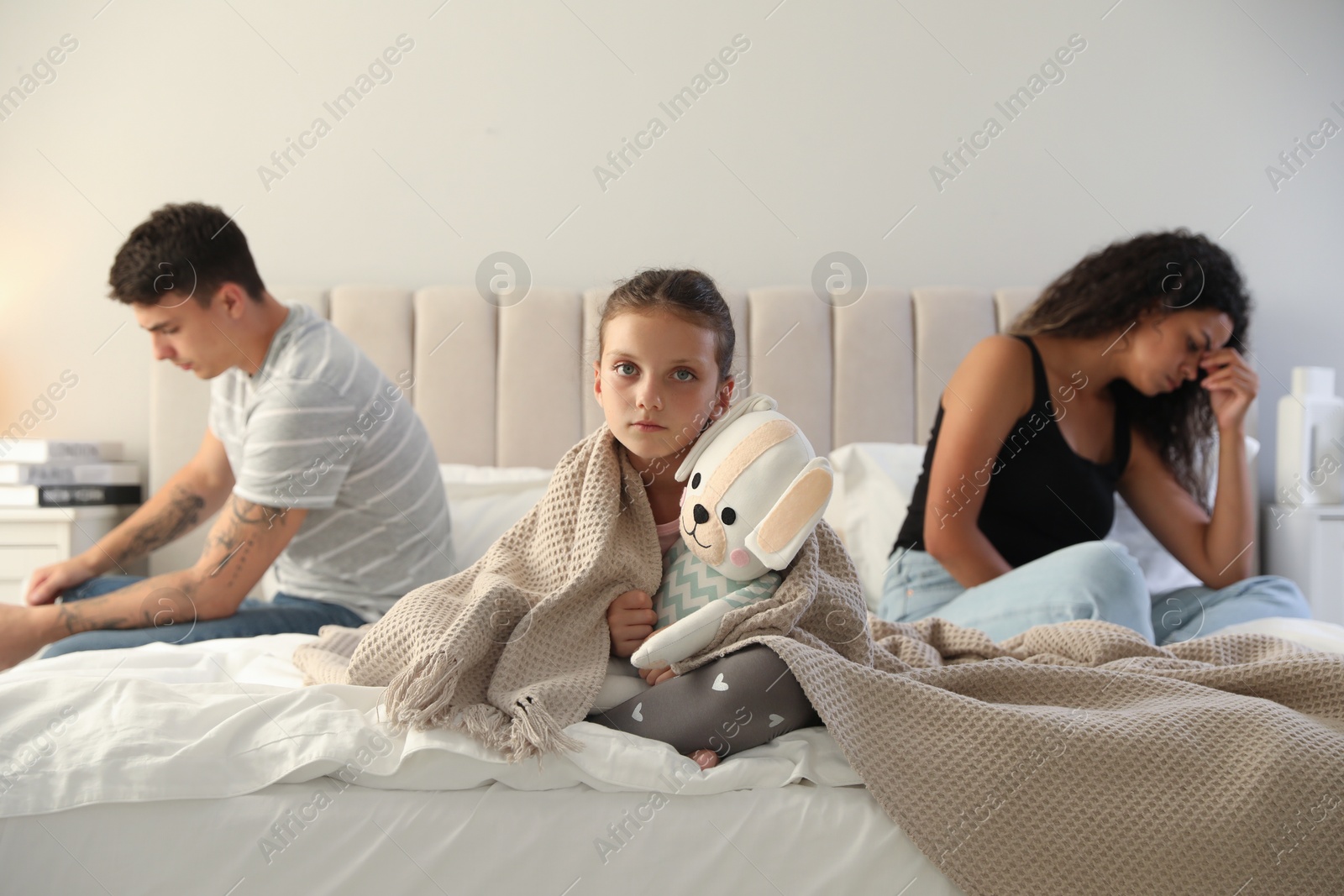 Photo of Divorce concept. Sad couple in bedroom, focus on their unhappy daughter