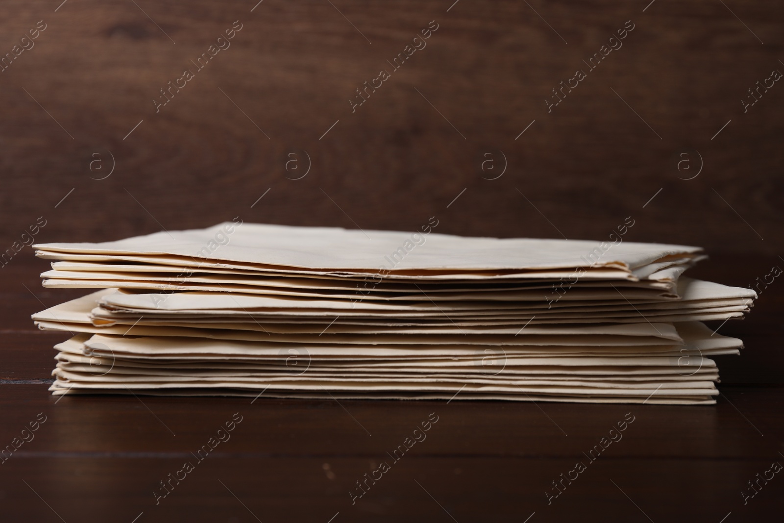 Photo of Stack of old letters on wooden table, closeup