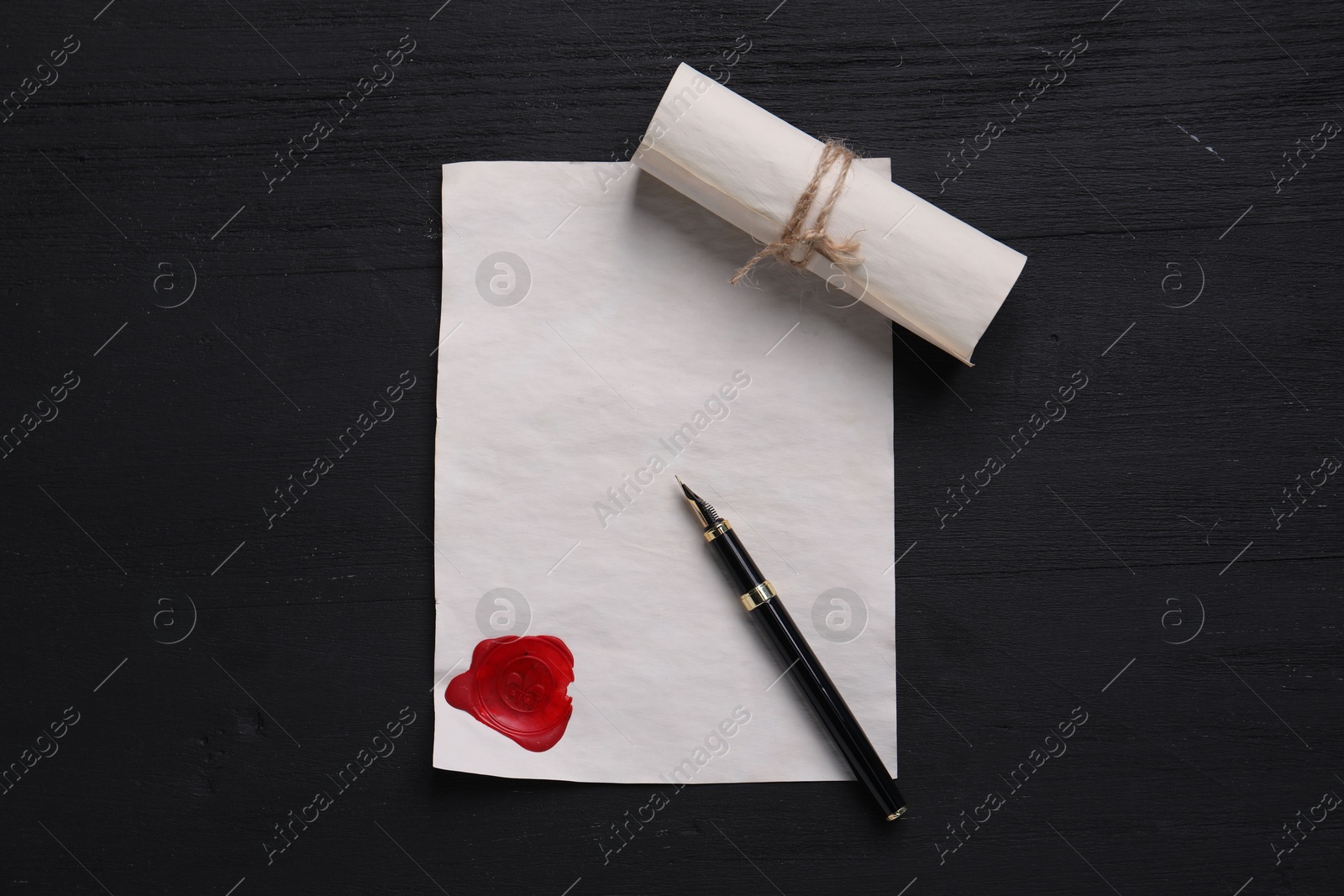 Photo of Old letters and fountain pen on black wooden table, top view