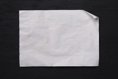 Blank old letter on black wooden table, top view