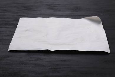 Blank old letter on black wooden table, closeup