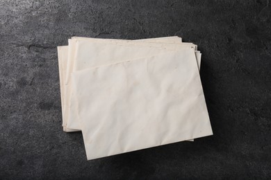 Photo of Old letter envelopes on grey table, top view