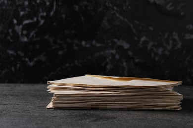 Photo of Stack of old letter envelopes on grey table