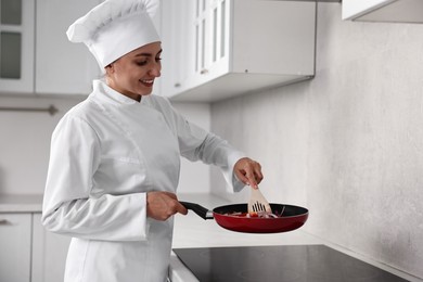 Photo of Professional chef cooking delicious food on stove in kitchen