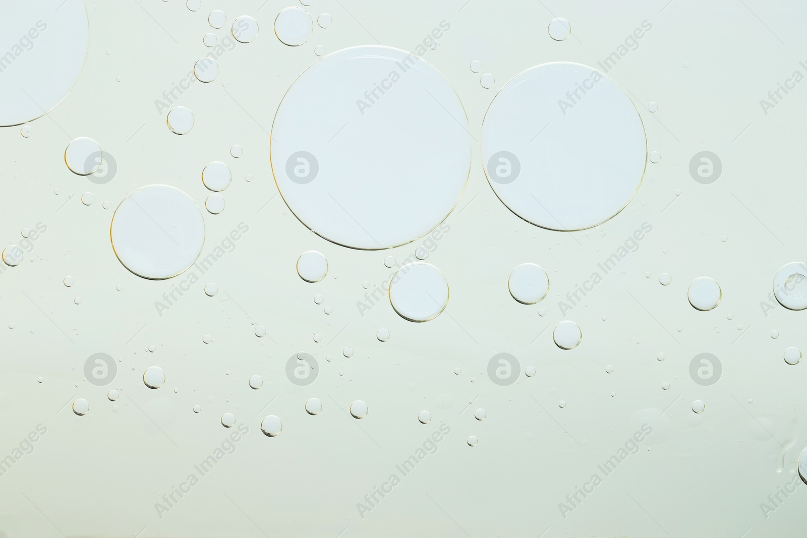 Photo of Sample of cosmetic oil on light grey background, macro view