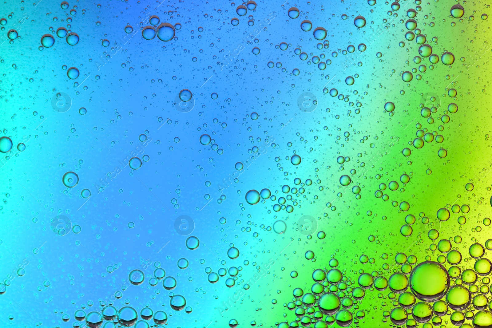 Photo of Essential oil bubbles on color background, macro view. Cosmetic product