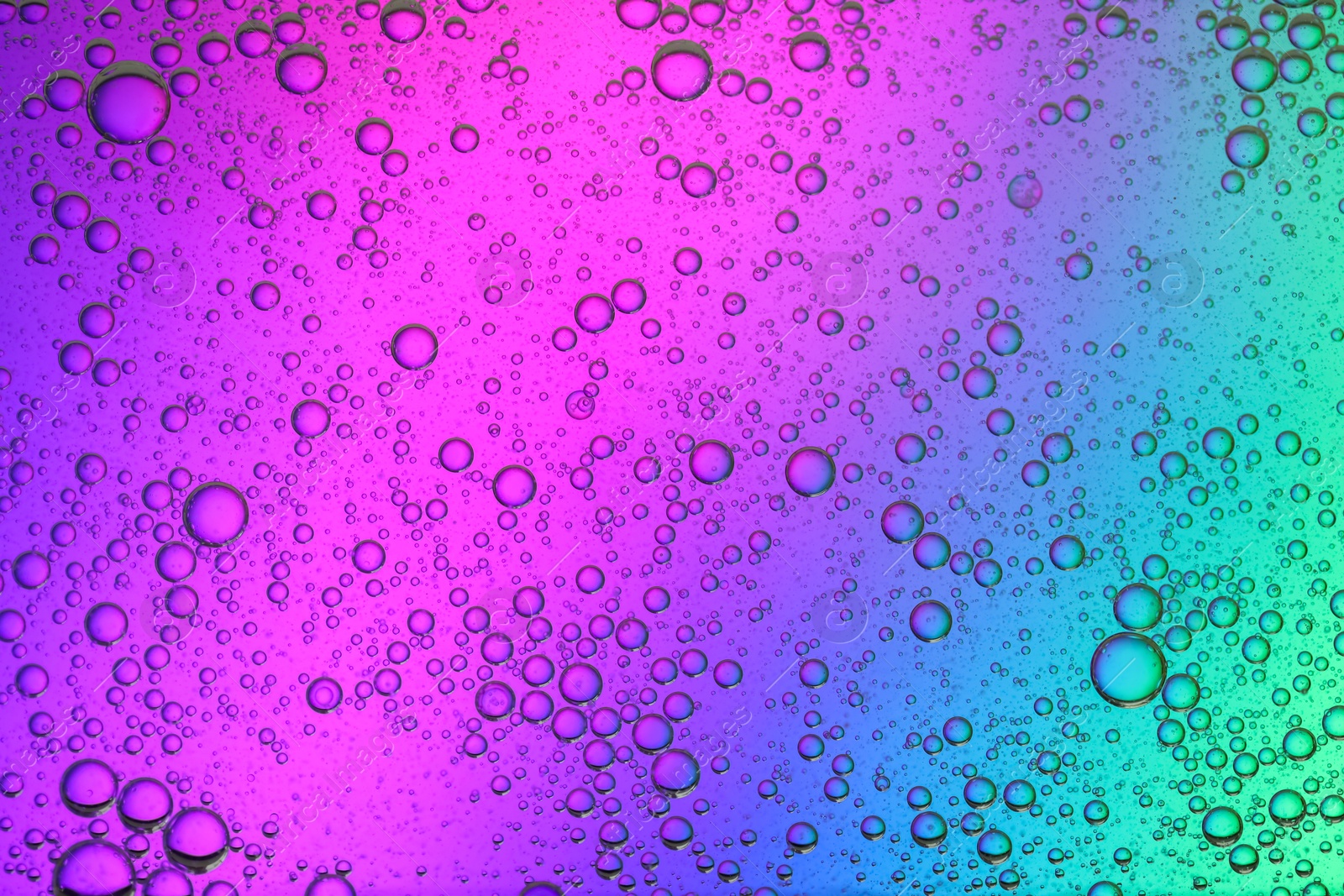 Photo of Essential oil bubbles on color background, macro view. Cosmetic product