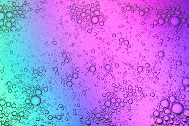 Essential oil bubbles on color background, macro view. Cosmetic product