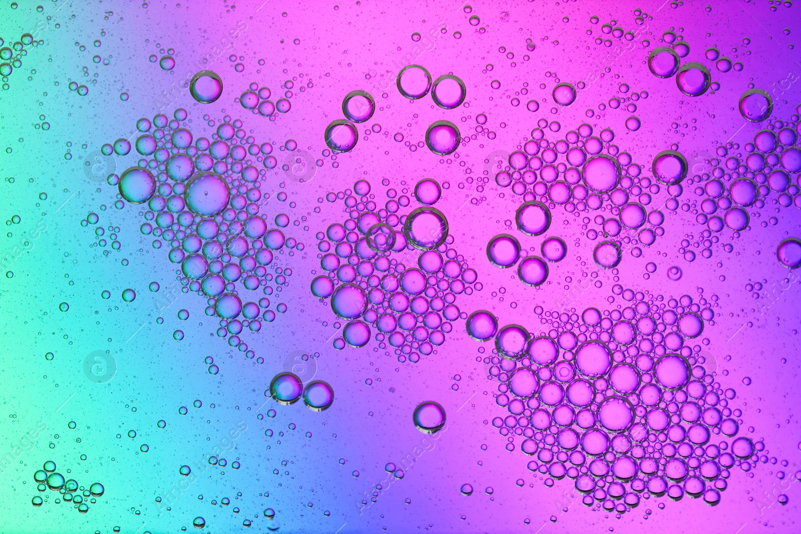 Photo of Essential oil bubbles on color background, macro view. Cosmetic product