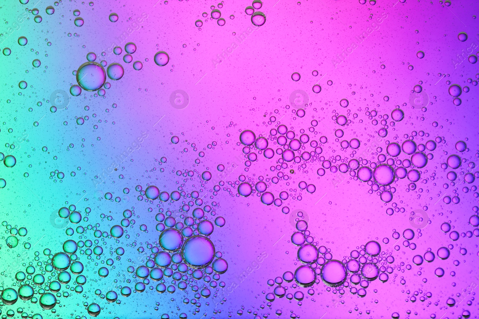 Photo of Essential oil bubbles on color background, macro view. Cosmetic product