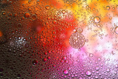 Essential oil bubbles on color background, macro view. Cosmetic product