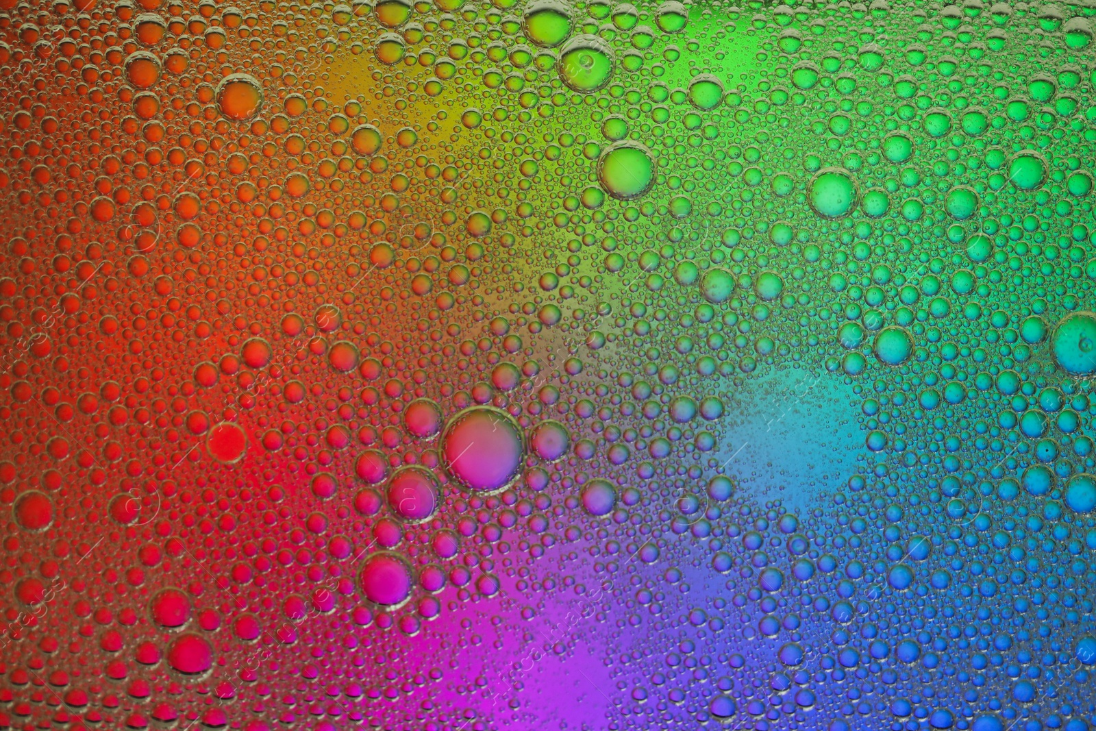 Photo of Essential oil bubbles on color background, macro view. Cosmetic product