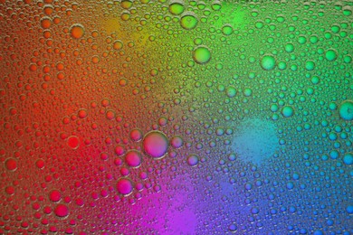 Essential oil bubbles on color background, macro view. Cosmetic product