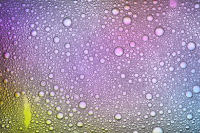 Essential oil bubbles on color background, macro view. Cosmetic product