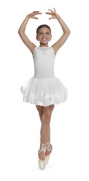 Little ballerina practicing dance moves on white background