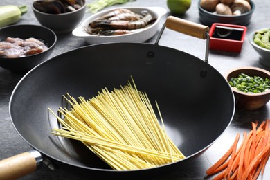 Photo of Different ingredients for wok on grey table