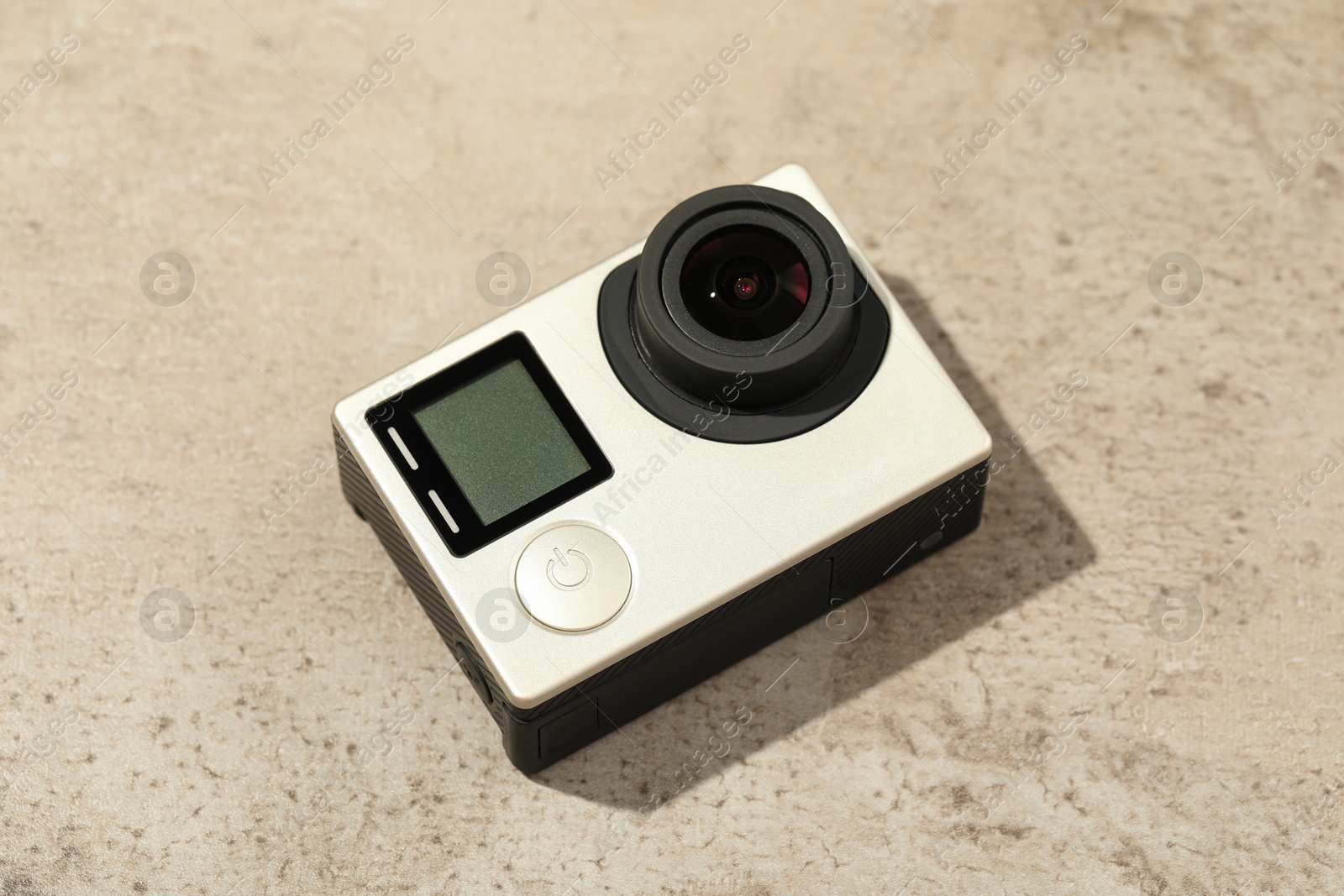 Photo of Modern action camera on grey stone surface