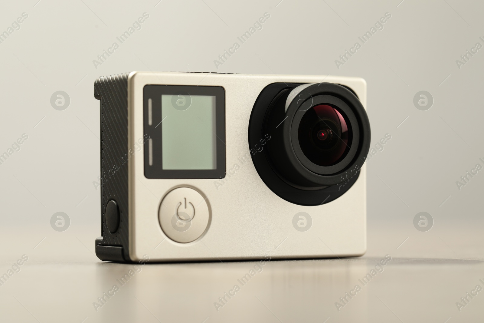 Photo of Modern action camera on light grey background, closeup