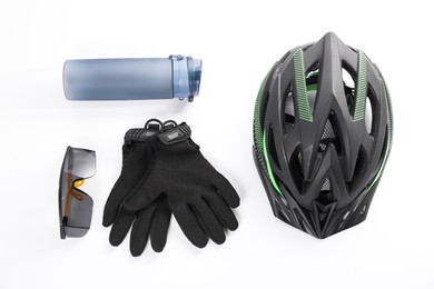 Bicycle helmet, thermo bottle, gloves and goggles on white background, flat lay