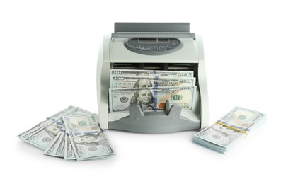 Money counter machine and dollar banknotes isolated on white