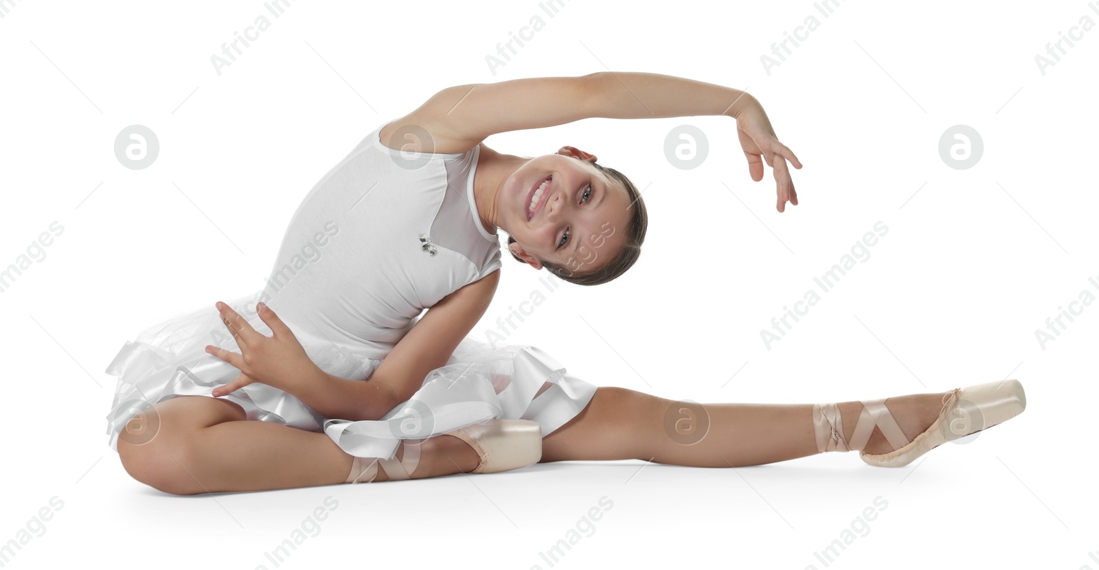 Photo of Cute little ballerina stretching on white background