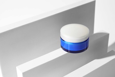 Stylish presentation of facial cream on white background