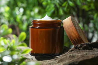 Stylish presentation of facial cream in jar outdoors, closeup