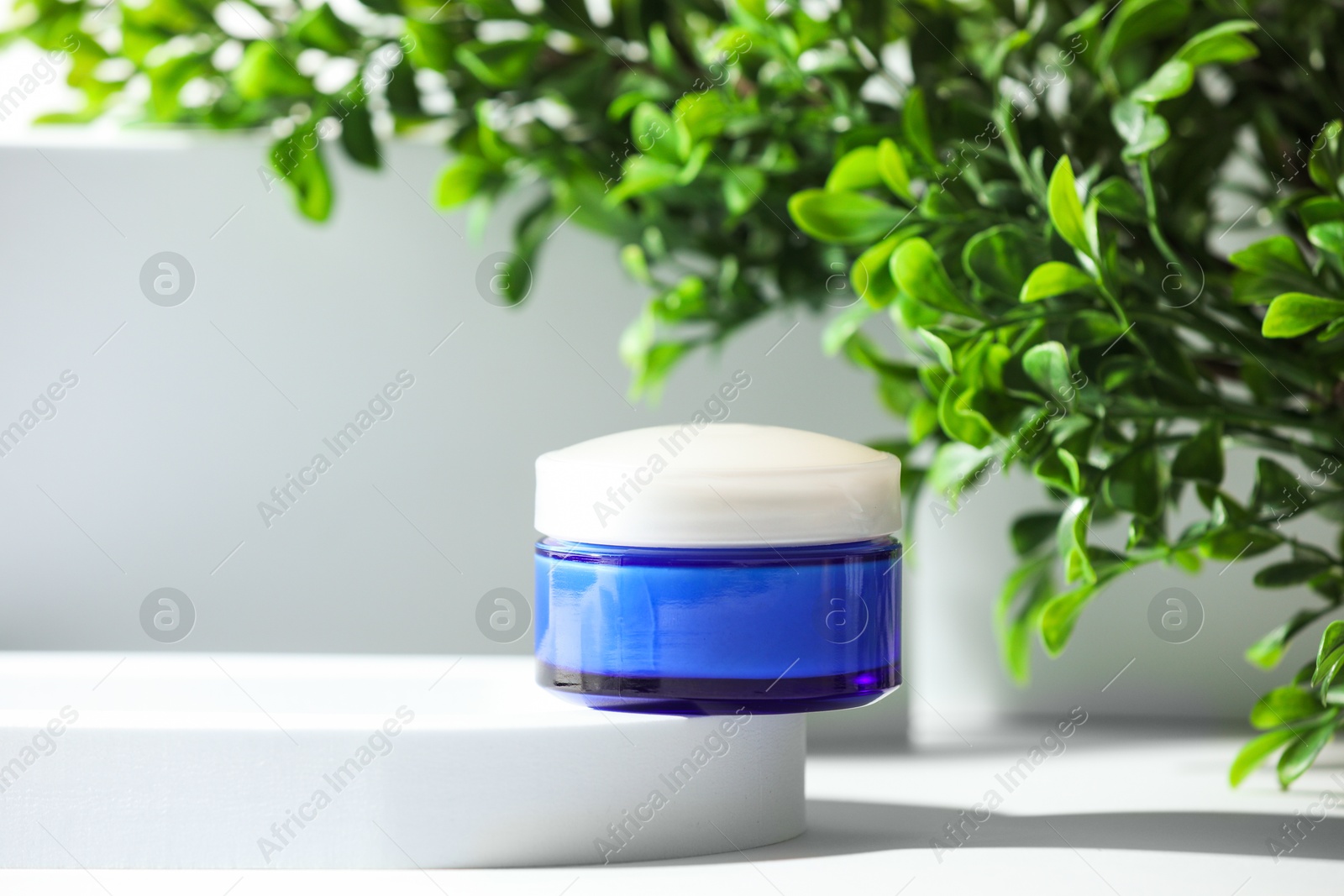 Photo of Stylish presentation of facial cream on white table