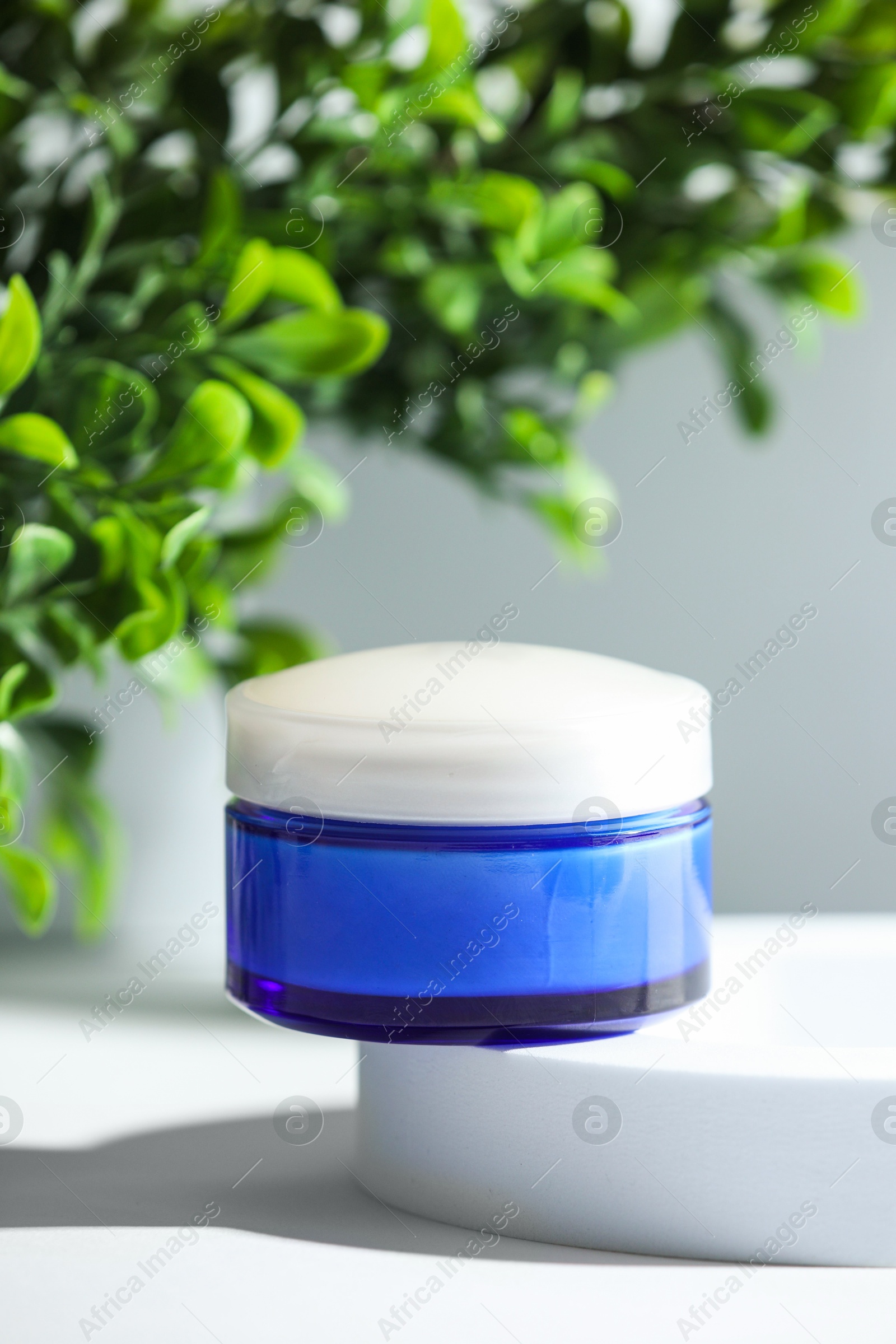 Photo of Stylish presentation of facial cream on white table