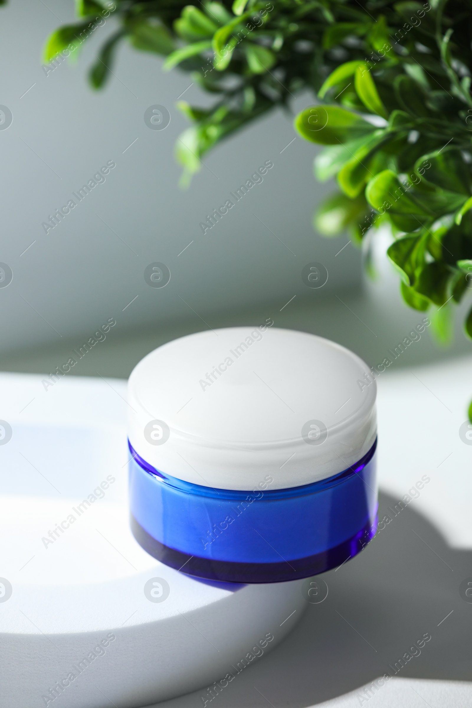 Photo of Stylish presentation of facial cream on white table