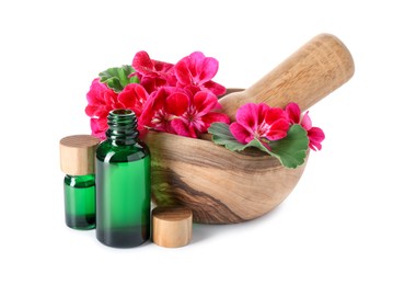 Photo of Geranium essential oil in bottles, beautiful flowers, mortar and pestle isolated on white