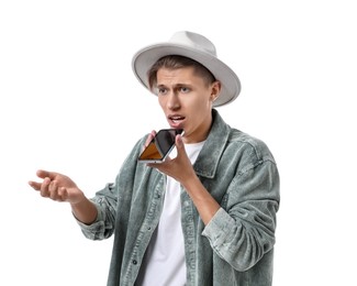 Photo of Young man in hat recording voice message via smartphone on white background