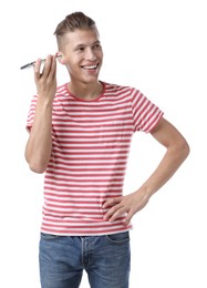 Young man with smartphone listening to voice message on white background