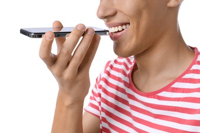 Photo of Young man recording voice message via smartphone on white background, closeup