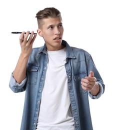 Young man with smartphone listening to voice message on white background