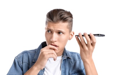 Photo of Young man with smartphone listening to voice message on white background