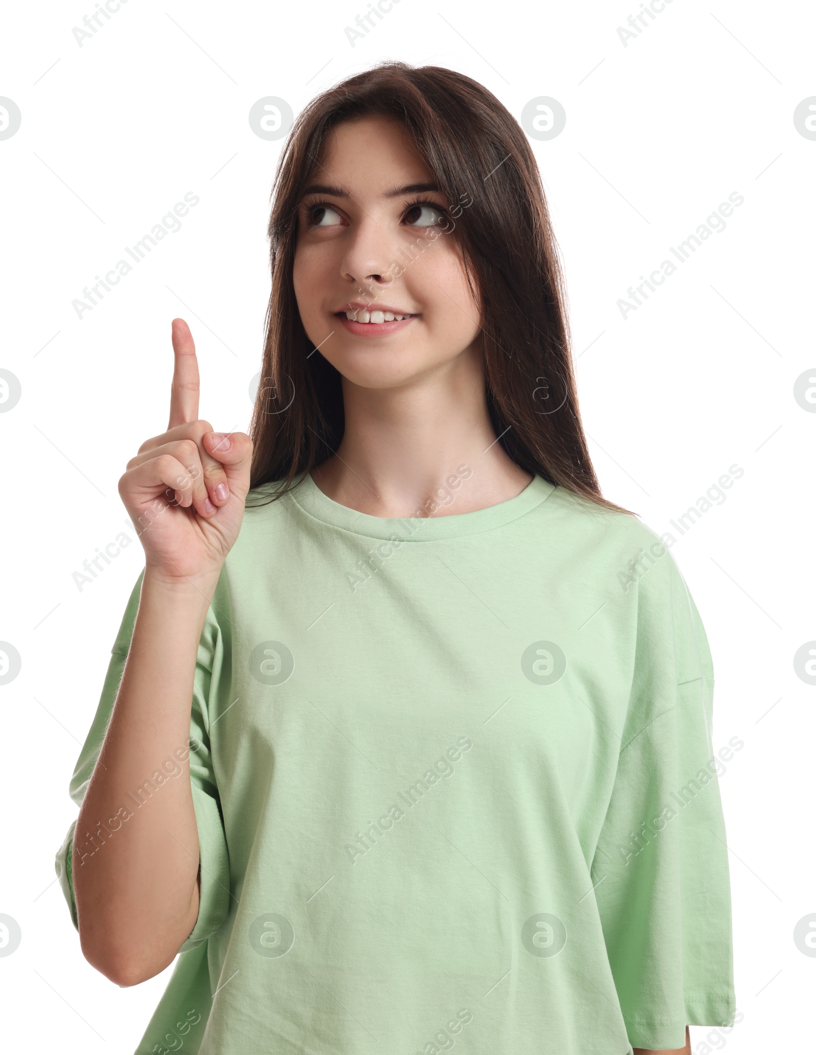 Photo of Portrait of cute teenage girl pointing at something on white background