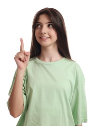 Photo of Portrait of cute teenage girl pointing at something on white background