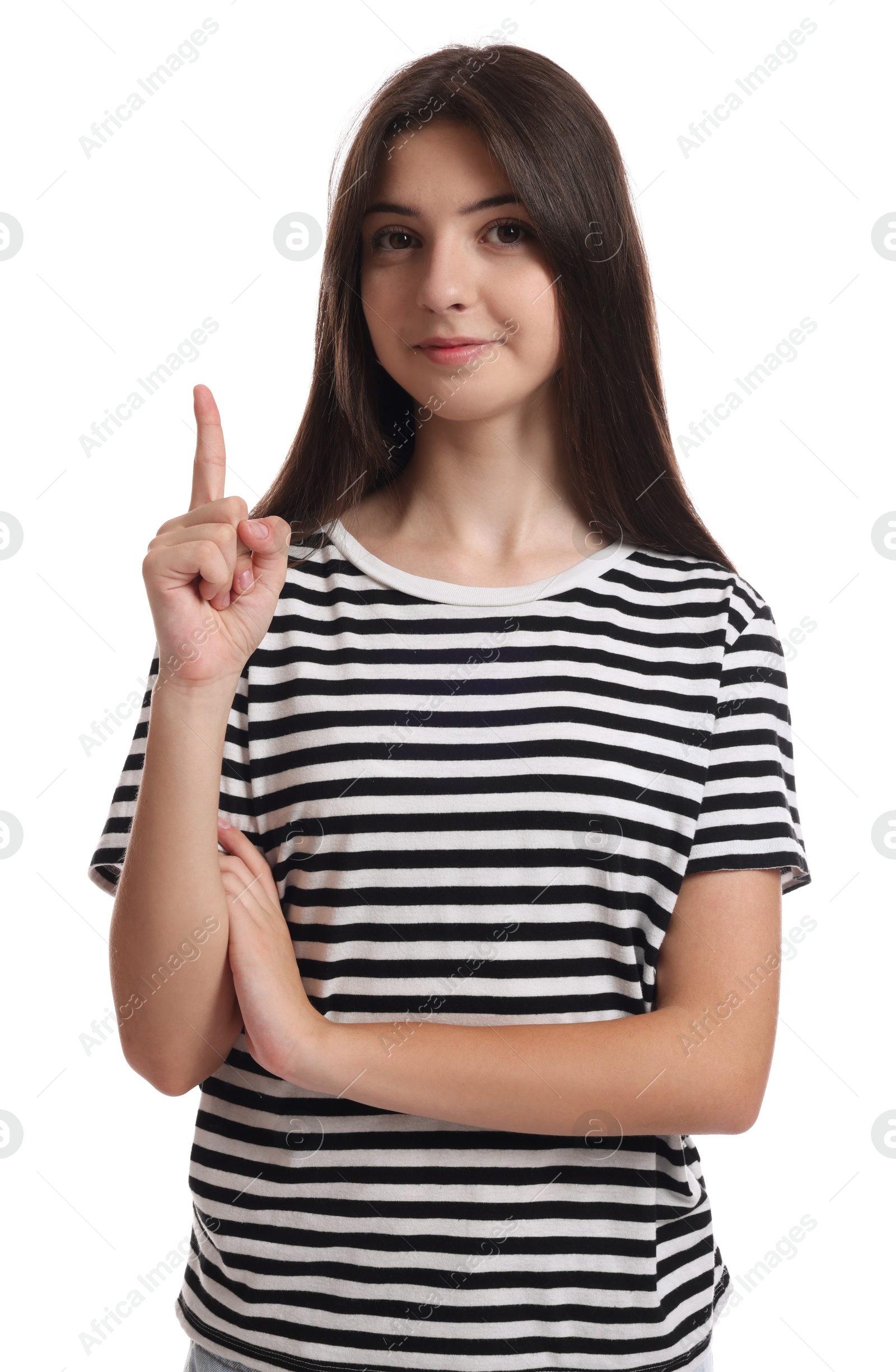 Photo of Portrait of cute teenage girl pointing at something on white background