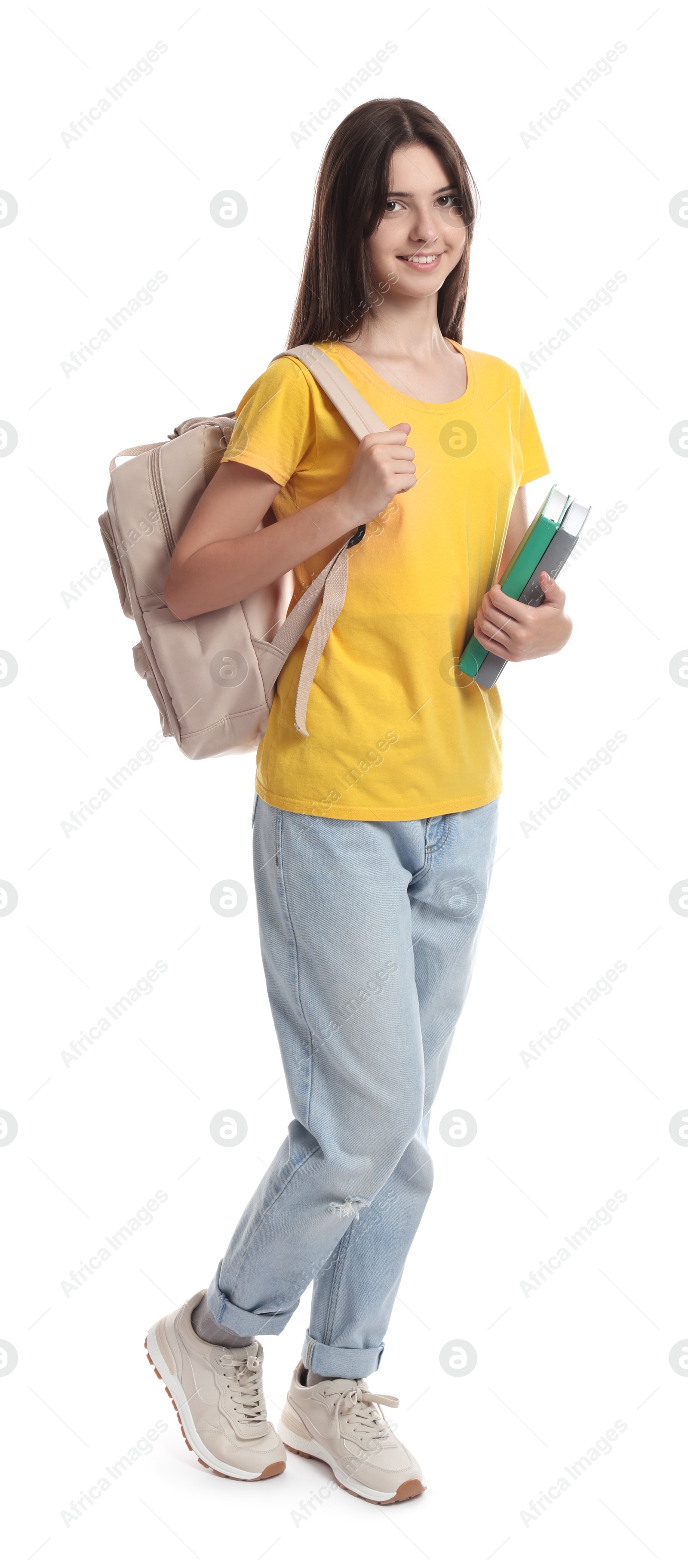 Photo of Cute teenage girl with backpack and books on white background