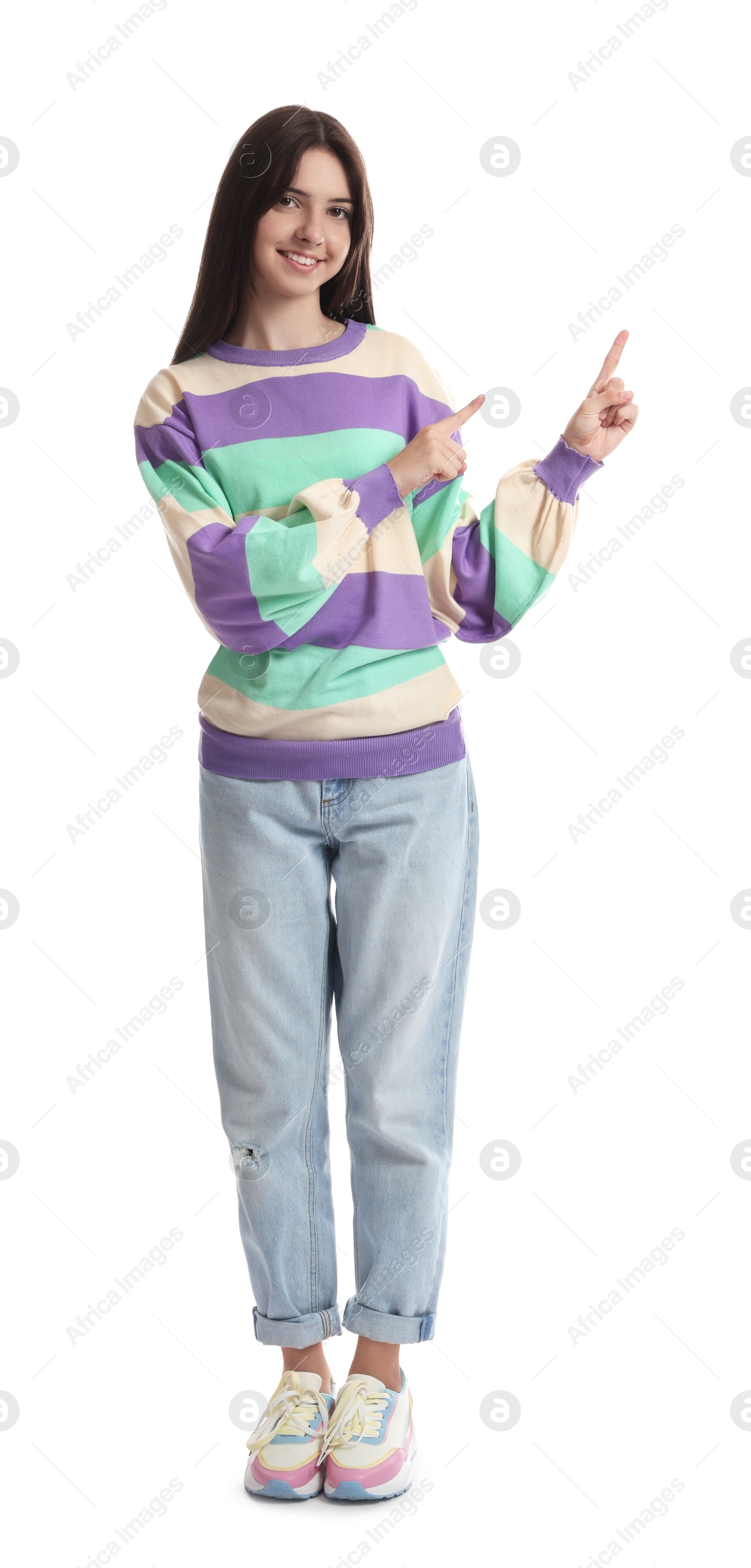 Photo of Cute teenage girl pointing at something on white background