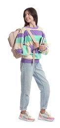 Smiling teenage girl with backpack and books on white background